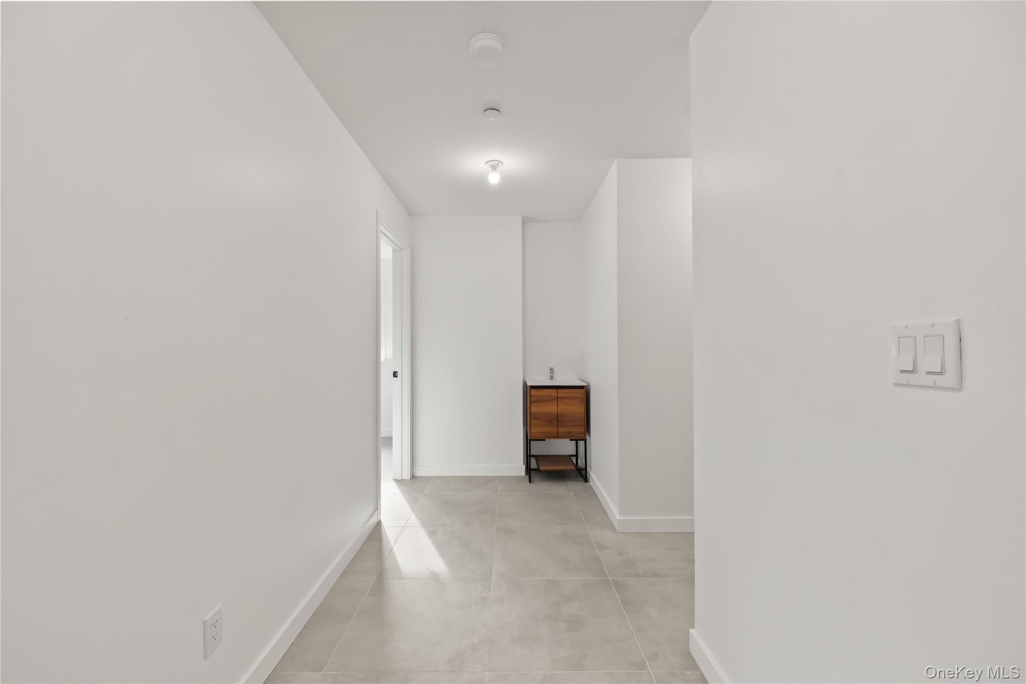 23 Singer Avenue, Unit 211 Spring Valley, NY 10977 - Photo 40 of 45 a view of an empty room with a kitchen
