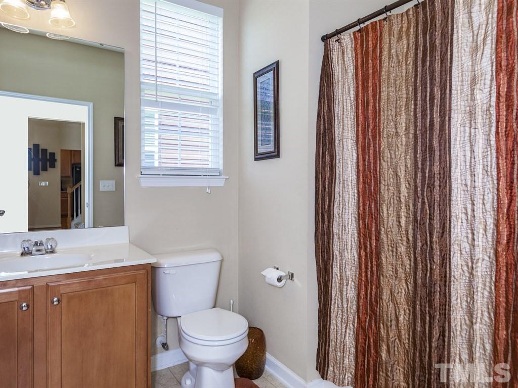 300 Hope Valley Road Knightdale, NC 27545 - Photo 11 of 25 a bathroom with a toilet a sink and a mirror