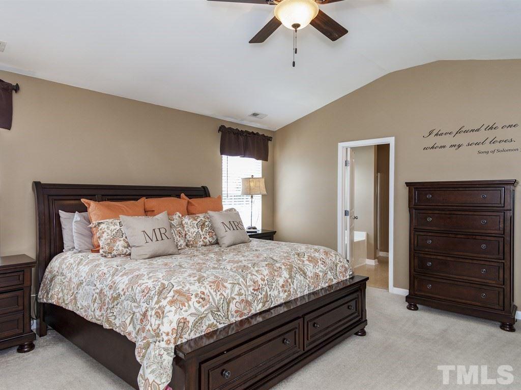 300 Hope Valley Road Knightdale, NC 27545 - Photo 12 of 25 a bedroom with a large bed and a chandelier