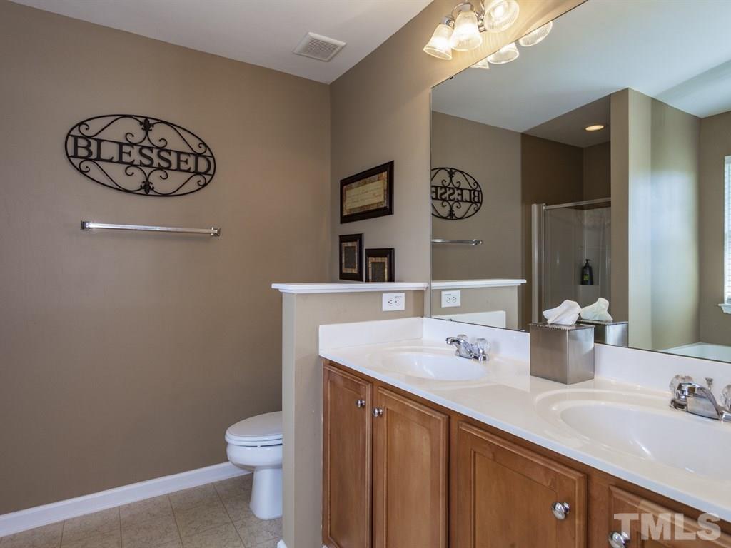 300 Hope Valley Road Knightdale, NC 27545 - Photo 13 of 25 a bathroom with a sink a toilet and mirror