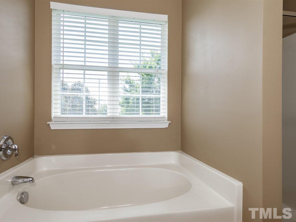 300 Hope Valley Road Knightdale, NC 27545 - Photo 14 of 25 a white bath tub sitting in a bathroom next to a window
