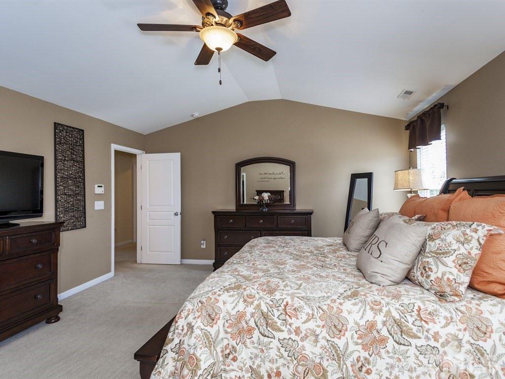 300 Hope Valley Road Knightdale, NC 27545 - Photo 16 of 25 a bedroom with a bed and a flat tv screen on dresser