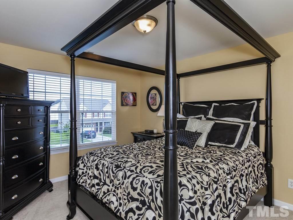 300 Hope Valley Road Knightdale, NC 27545 - Photo 17 of 25 a bedroom with a bed and a dresser next to a window