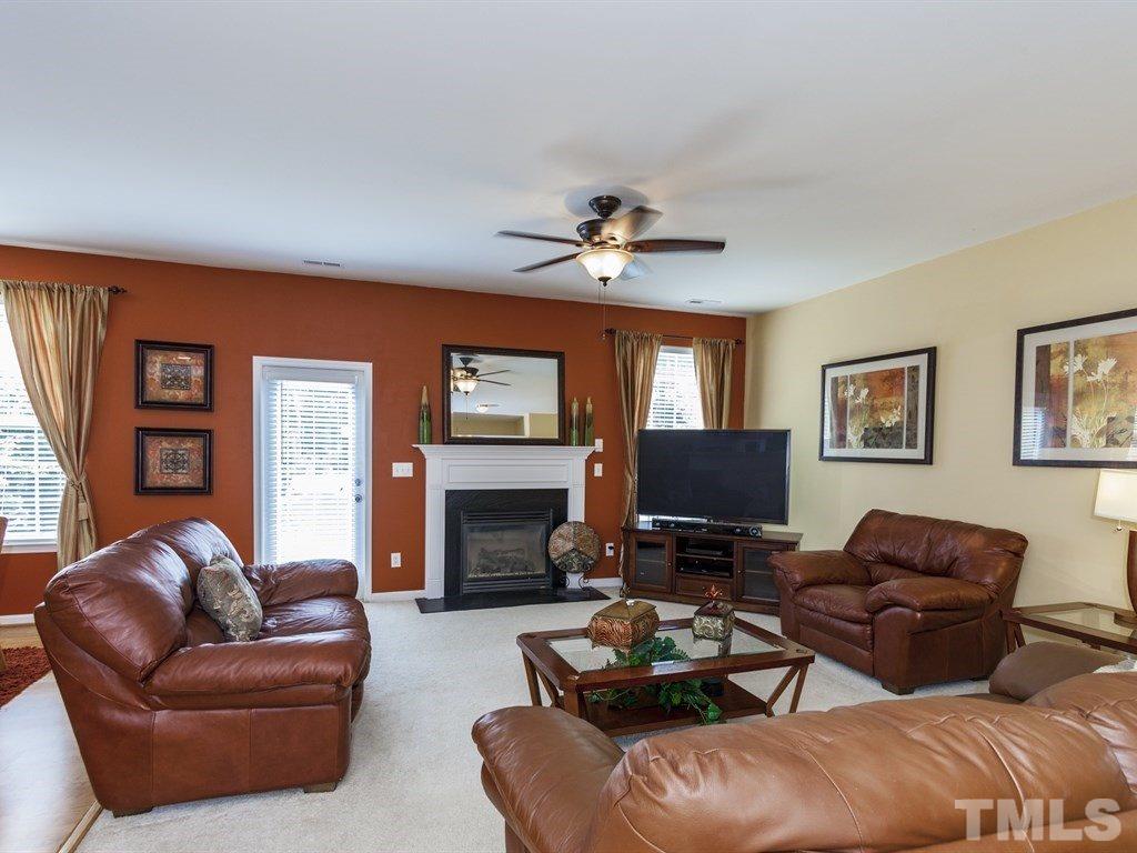 300 Hope Valley Road Knightdale, NC 27545 - Photo 5 of 25 a living room with furniture a fireplace and a flat screen tv