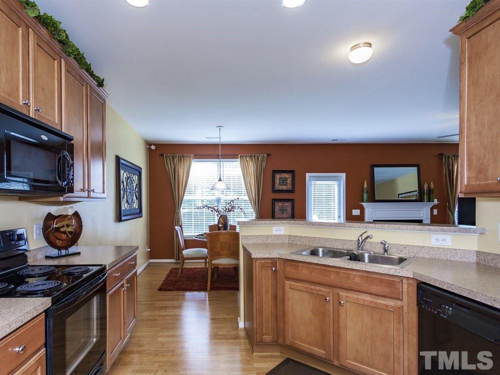 300 Hope Valley Road Knightdale, NC 27545 - Photo 6 of 25 a kitchen with granite countertop a stove a sink and a wooden cabinets
