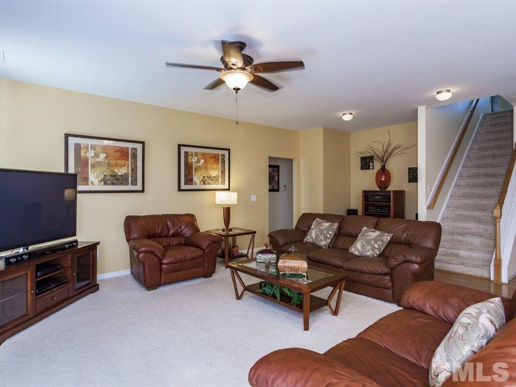 300 Hope Valley Road Knightdale, NC 27545 - Photo 10 of 25 a living room with furniture and a flat screen tv with wooden floor