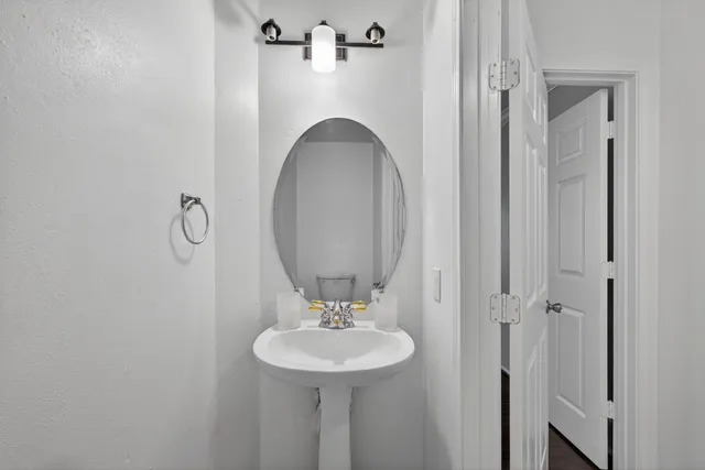 a bathroom with a sink a toilet and a mirror