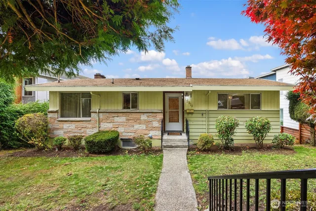 a front view of house with yard and green space