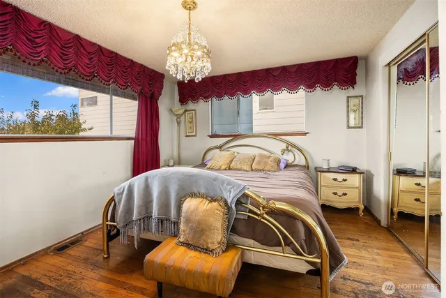 a bedroom with a bed and a chandelier