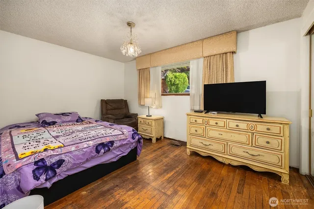 a bedroom with a bed and flat screen tv