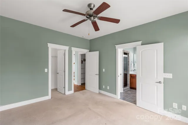 a view of a livingroom with a ceiling fan and entryway