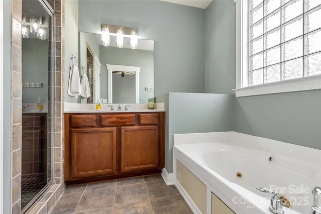 a bathroom with a bathtub a sink and a mirror