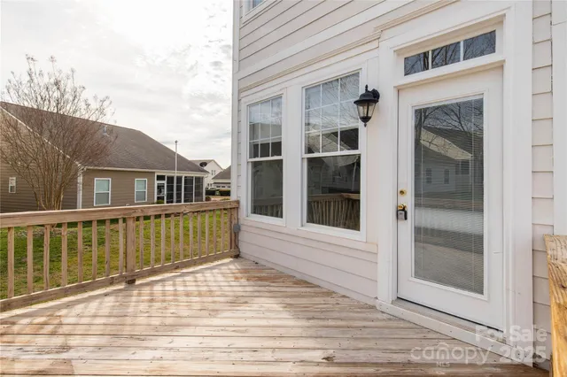 a view of a house with wooden deck