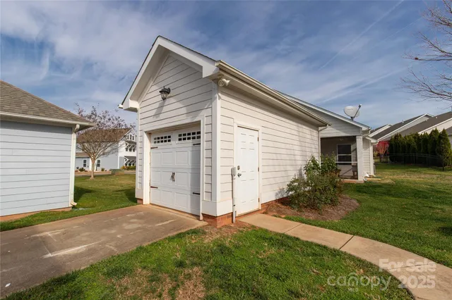 a view of a house with wooden deck and a yard