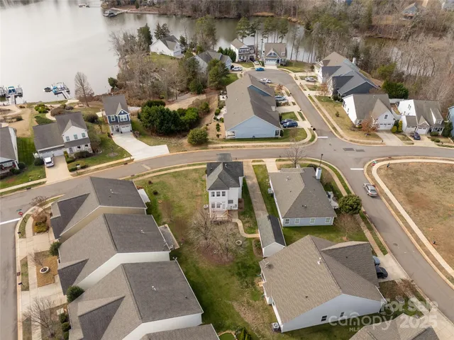 an aerial view of a house with outdoor space and a lake view