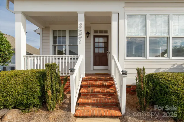 a view of a house with a window and wooden fence