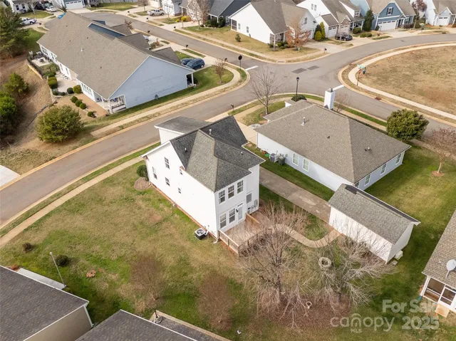 an aerial view of residential house with outdoor space and parking