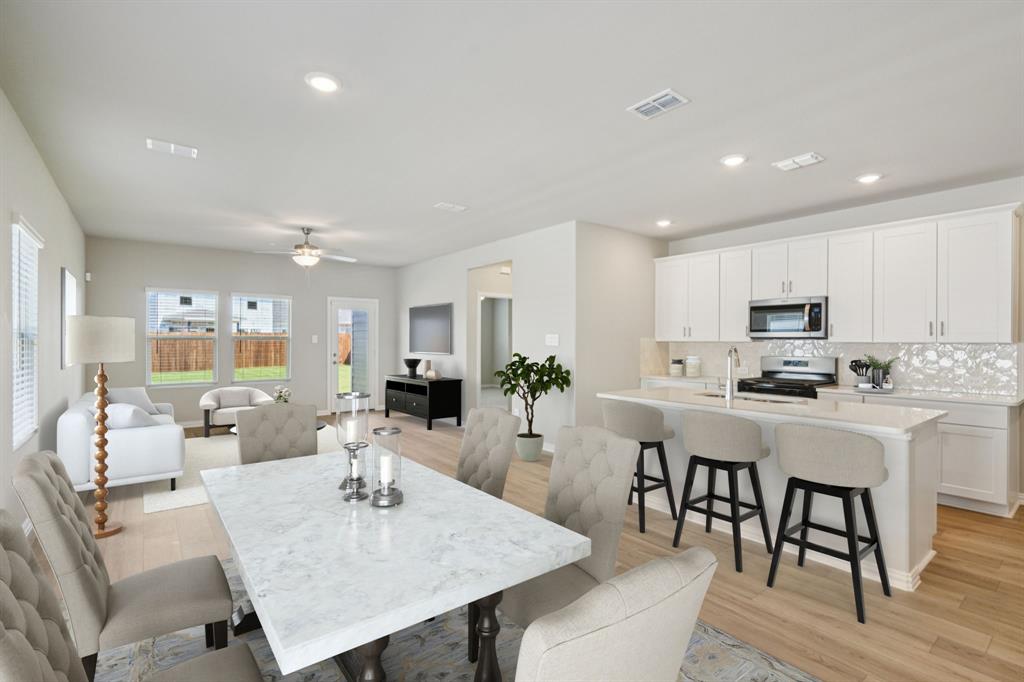 1712 Arches Road Anna, TX 75409 - Photo 14 of 37 a view of kitchen with sink dining table and chairs