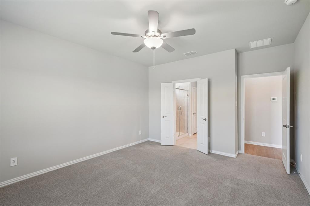 1712 Arches Road Anna, TX 75409 - Photo 17 of 37 a view of an empty room with a ceiling fan