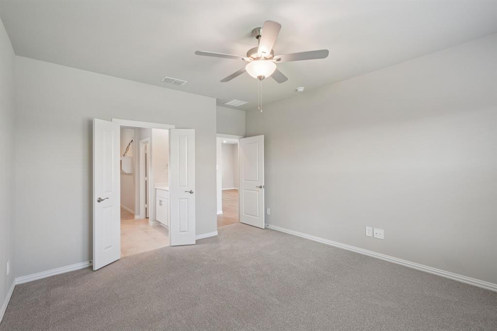 1712 Arches Road Anna, TX 75409 - Photo 18 of 37 an empty room with a ceiling fan and a window