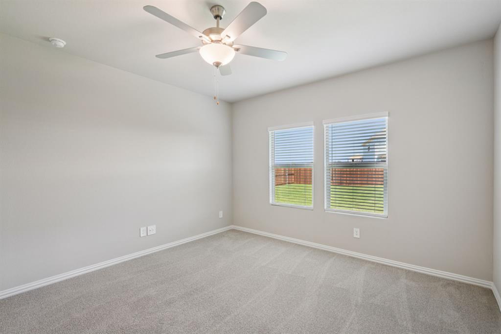 1712 Arches Road Anna, TX 75409 - Photo 19 of 37 an empty room with a window and a fan