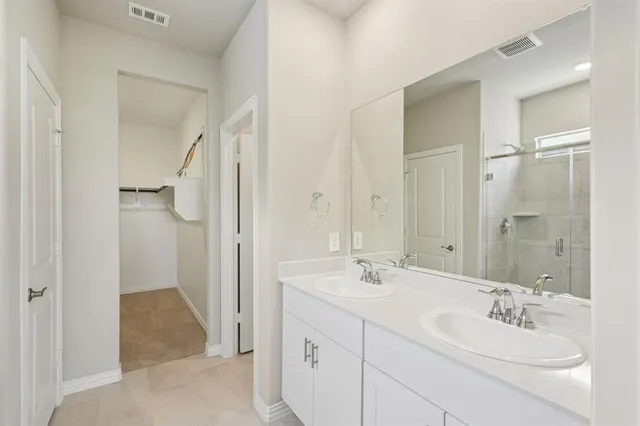 a bathroom with a double vanity sink mirror and double