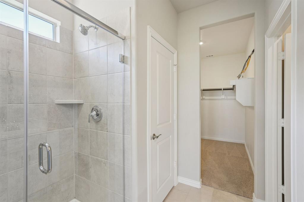 1712 Arches Road Anna, TX 75409 - Photo 21 of 37 a bathroom with a shower and a glass door