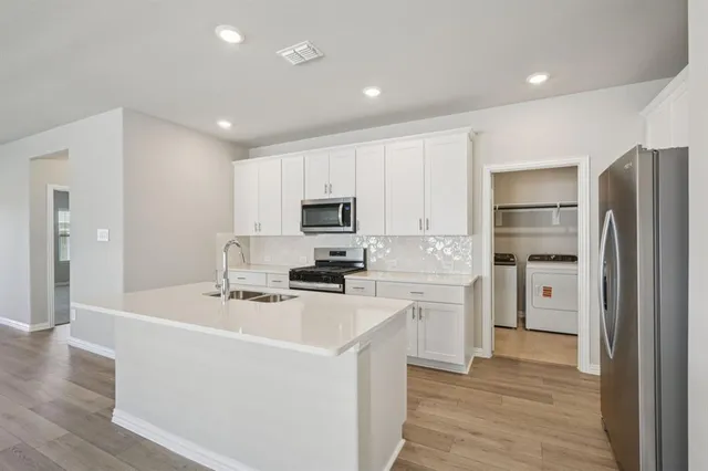 a kitchen with a refrigerator stove and sink