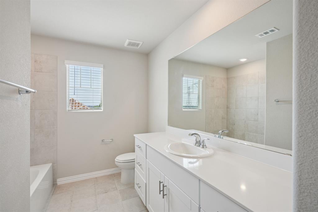 1712 Arches Road Anna, TX 75409 - Photo 35 of 37 a bathroom with a sink a toilet and a mirror