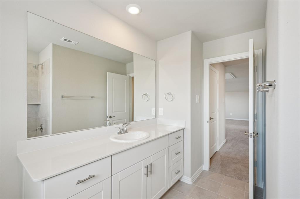 1712 Arches Road Anna, TX 75409 - Photo 36 of 37 a bathroom with a sink a mirror and a shower