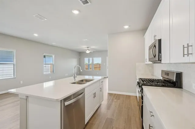 a kitchen that has a sink and a stove in it