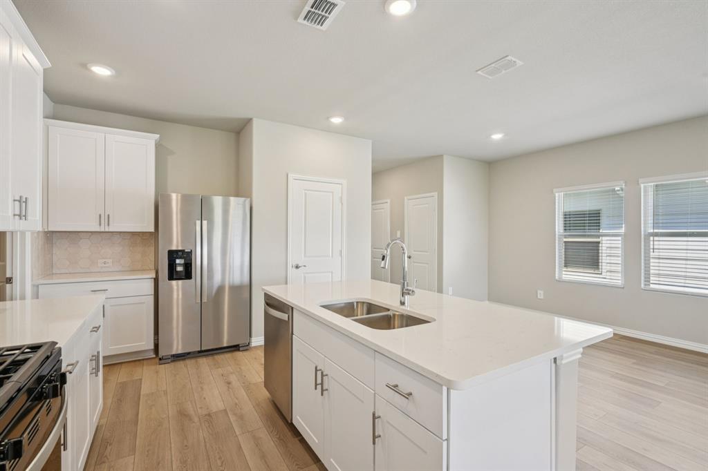1712 Arches Road Anna, TX 75409 - Photo 7 of 37 a kitchen with a sink appliances and cabinets