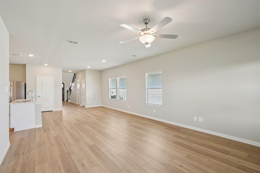 1712 Arches Road Anna, TX 75409 - Photo 9 of 37 a view of an empty room with wooden floor and a window