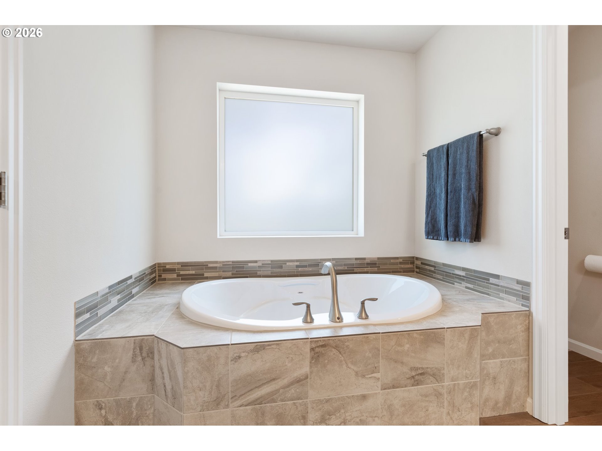16185 Northwest Liberty Street Portland, OR 97229 - Photo 19 of 33 a bath tub sitting in a bathroom next to a sink