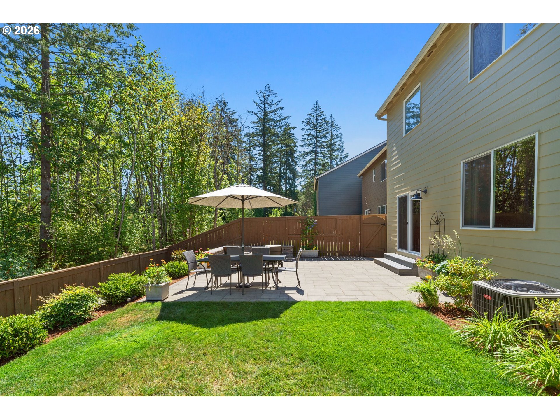 16185 Northwest Liberty Street Portland, OR 97229 - Photo 31 of 33 a view of a patio with table and chairs under an umbrella