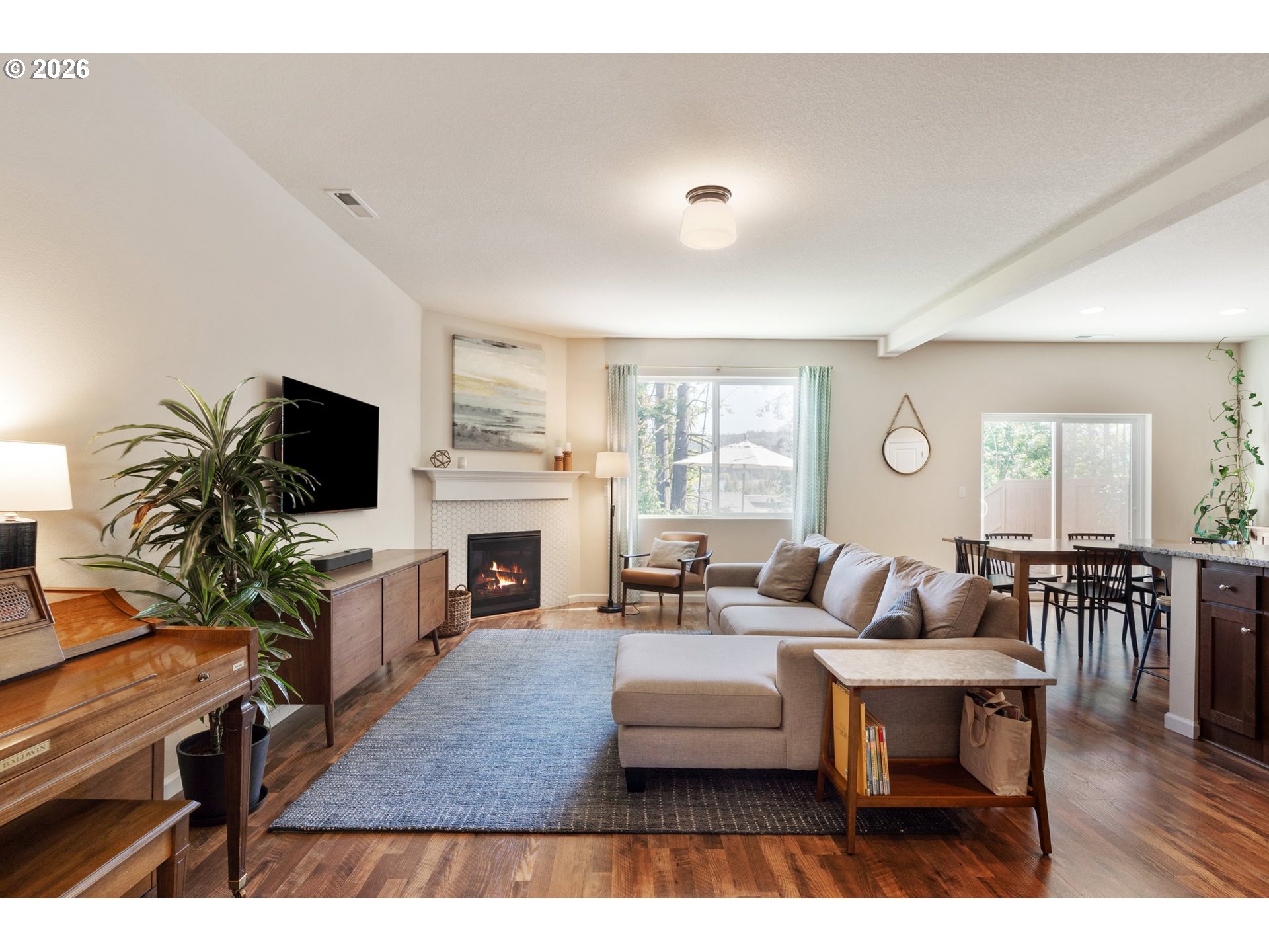16185 Northwest Liberty Street Portland, OR 97229 - Photo 5 of 33 a living room with furniture a fireplace a flat screen tv and a large window