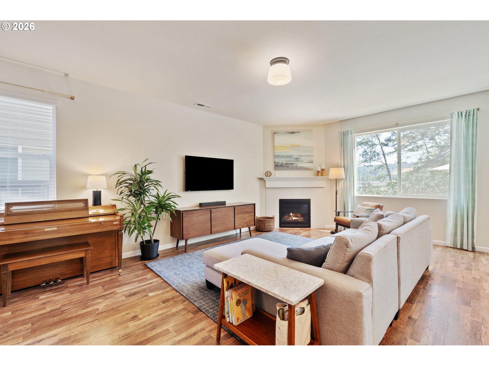 16185 Northwest Liberty Street Portland, OR 97229 - Photo 6 of 33 a living room with furniture a fireplace and a flat screen tv