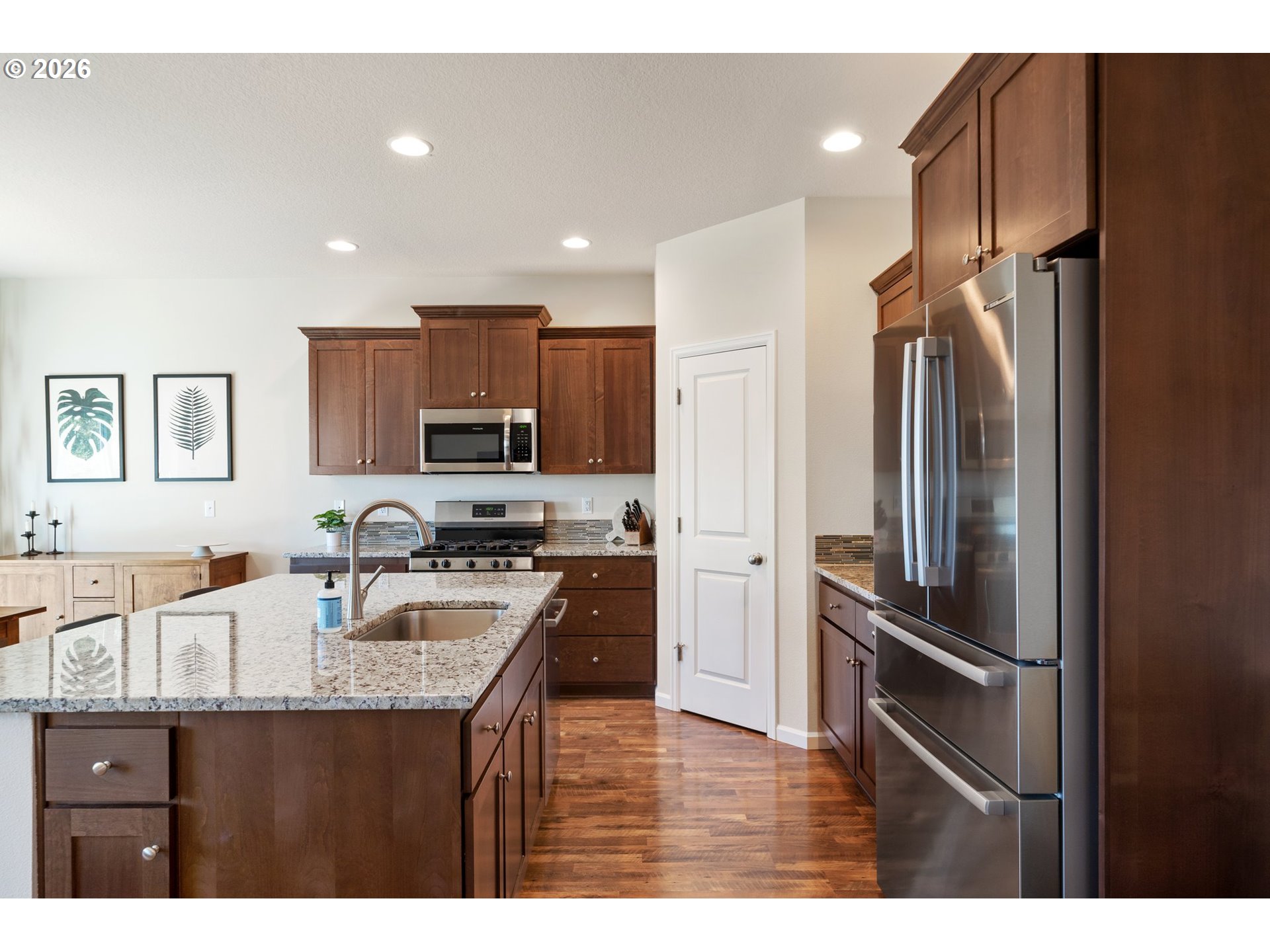16185 Northwest Liberty Street Portland, OR 97229 - Photo 9 of 33 a kitchen with kitchen island a counter top space stainless steel appliances and cabinets