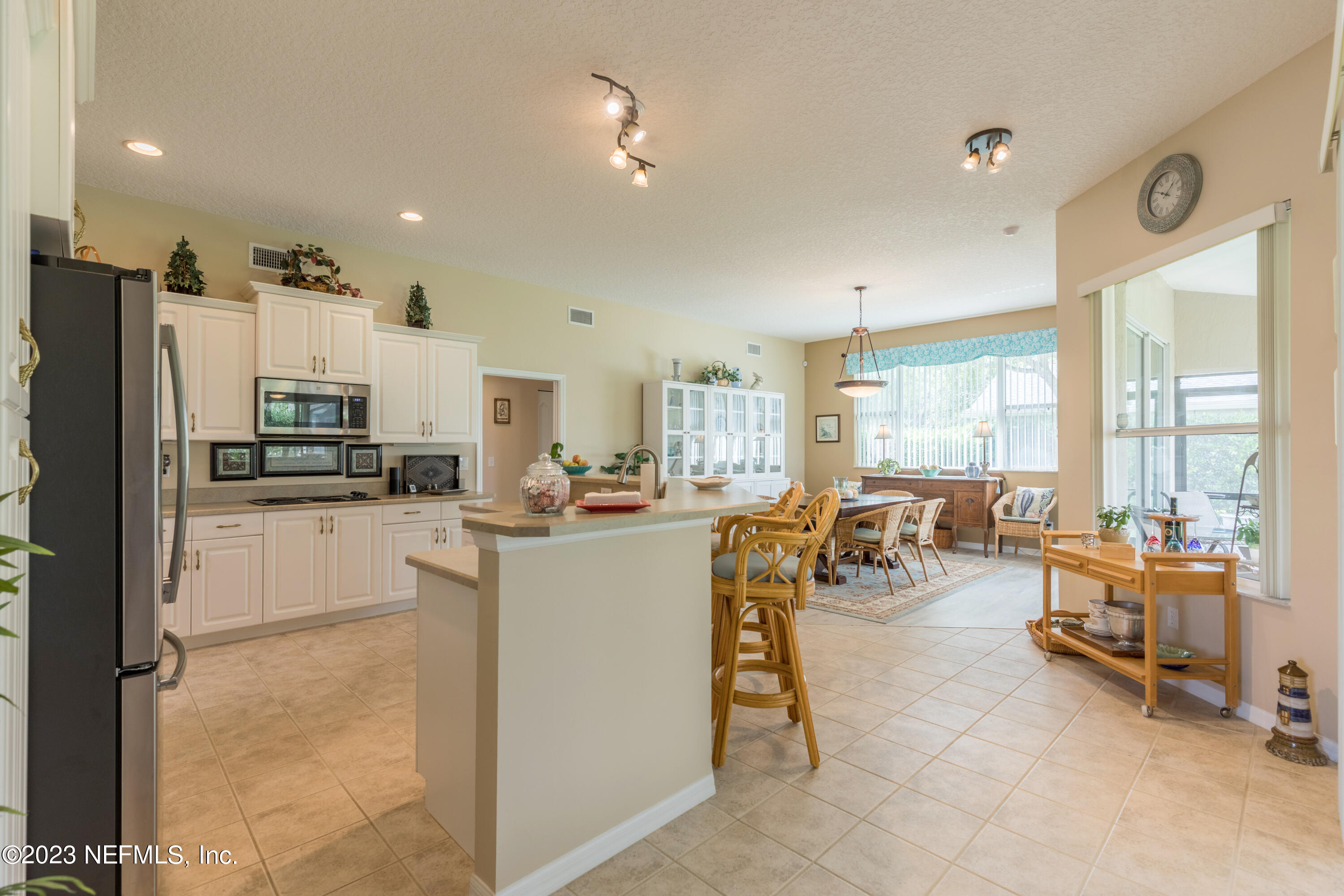 293 San Nicolas Way St. Augustine, FL 32080 - Photo 12 of 51 a kitchen with sink refrigerator dining table and chairs