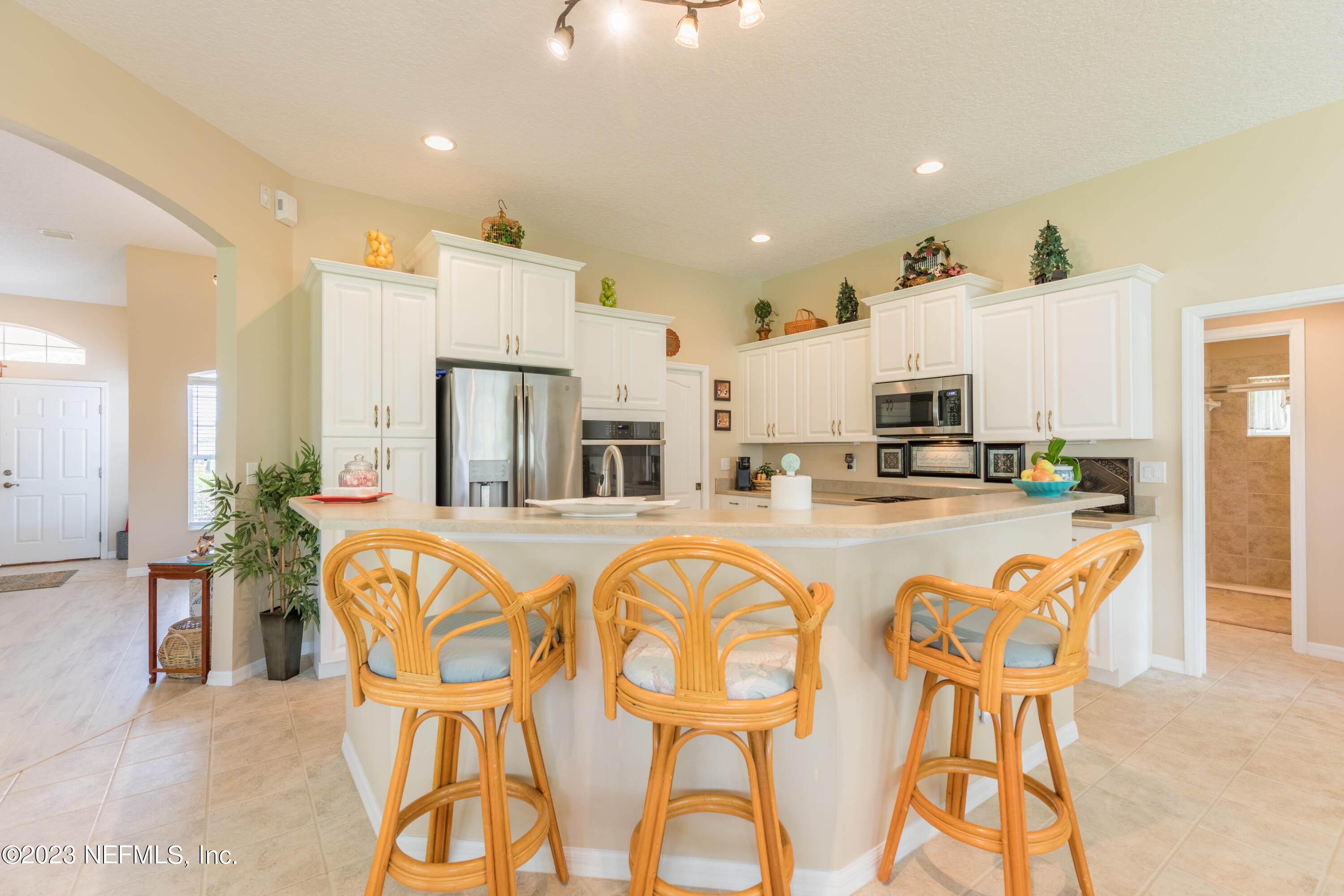 293 San Nicolas Way St. Augustine, FL 32080 - Photo 13 of 51 a kitchen with stainless steel appliances kitchen island granite countertop a refrigerator and microwave