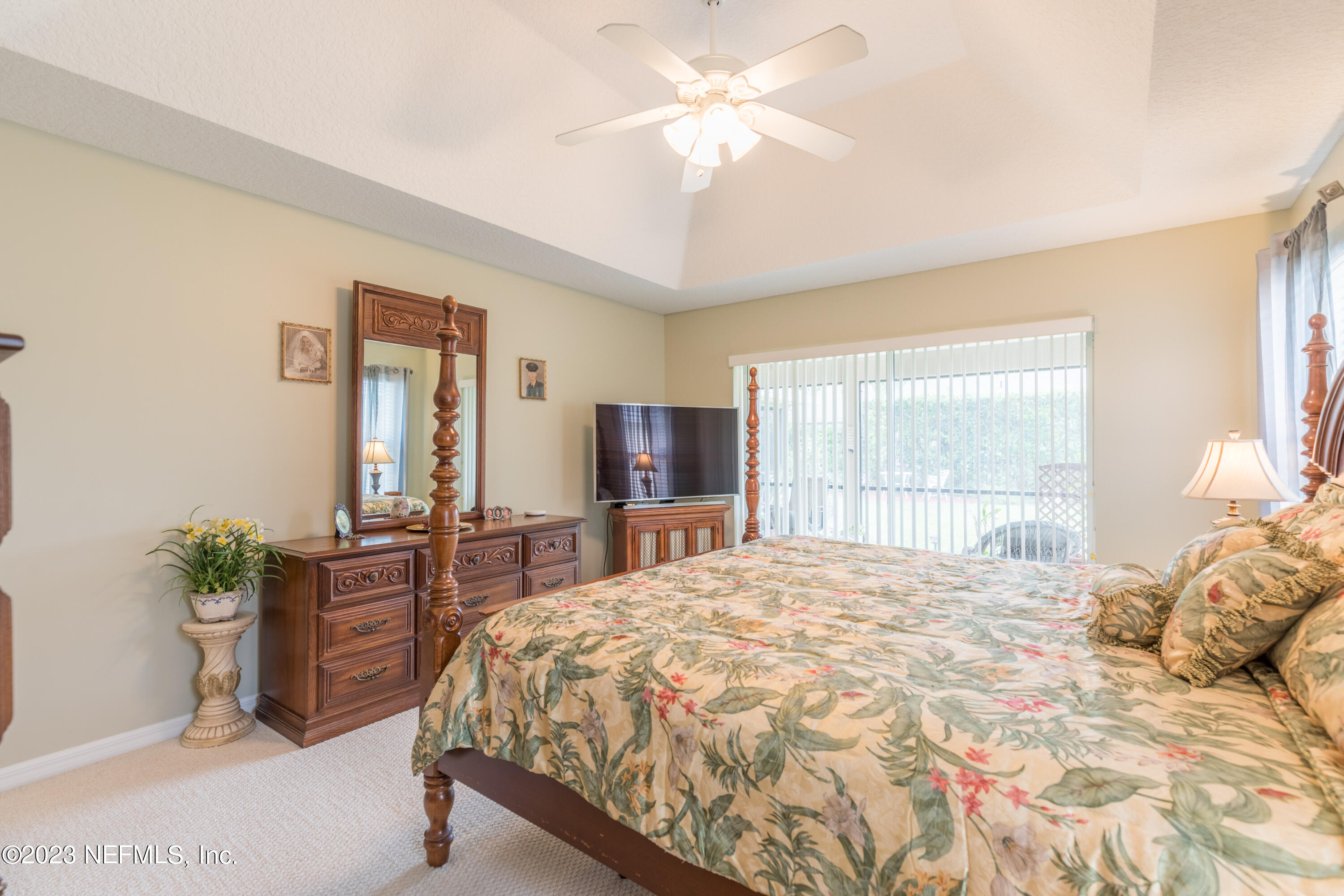 293 San Nicolas Way St. Augustine, FL 32080 - Photo 27 of 51 a bedroom with a large bed and a chandelier