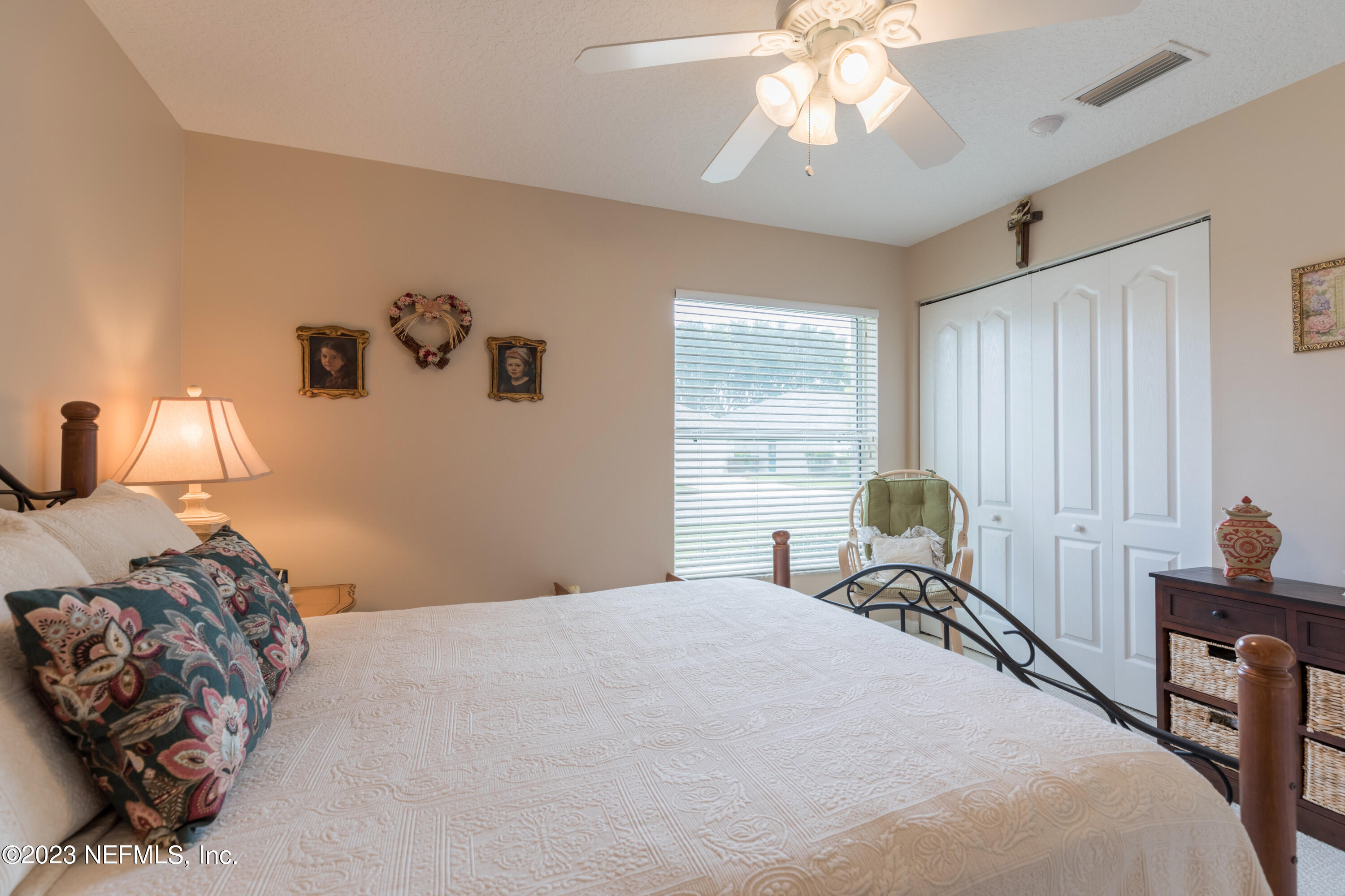 293 San Nicolas Way St. Augustine, FL 32080 - Photo 35 of 51 a bedroom with a bed and a chandelier