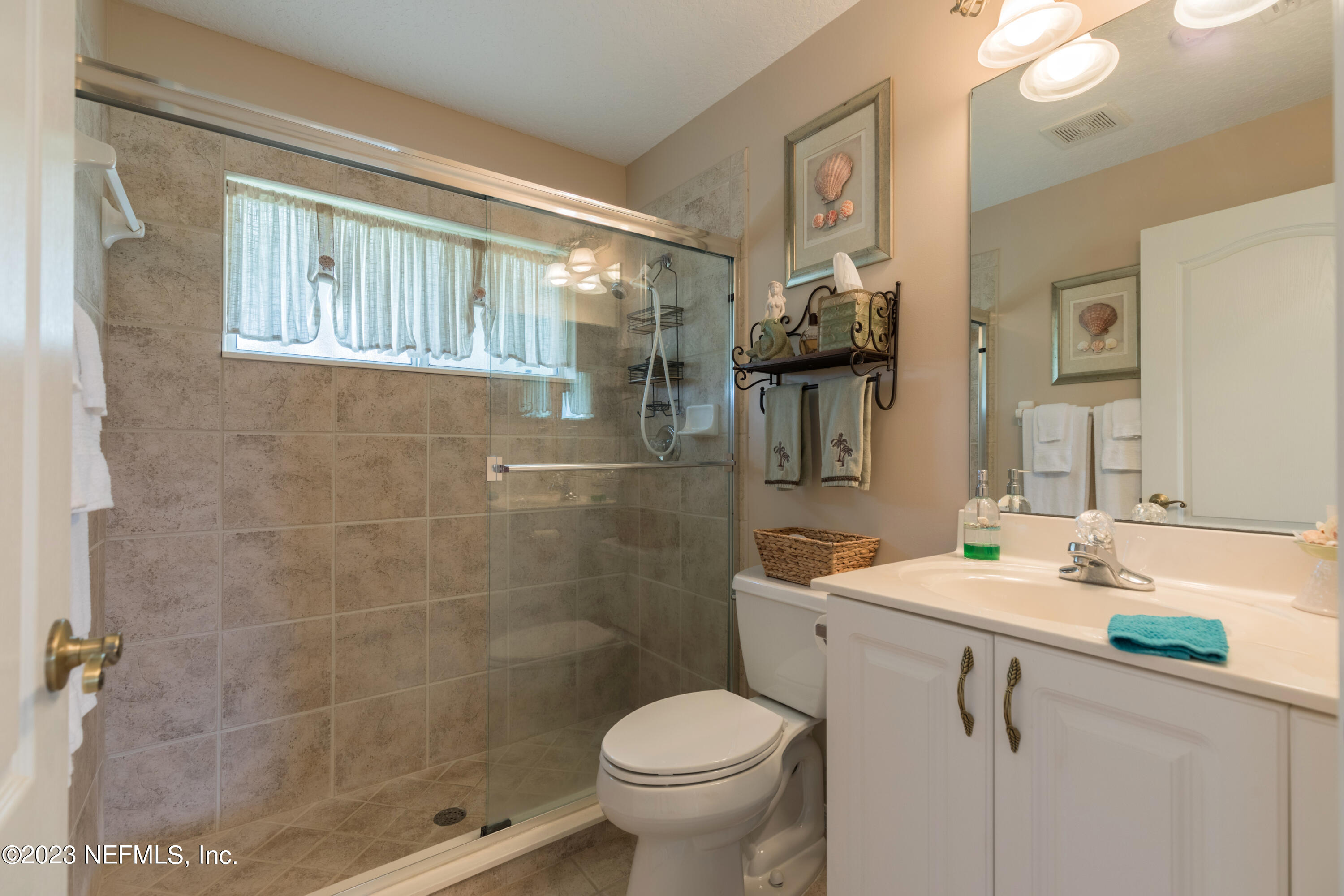 293 San Nicolas Way St. Augustine, FL 32080 - Photo 36 of 51 a bathroom with a toilet sink and mirror