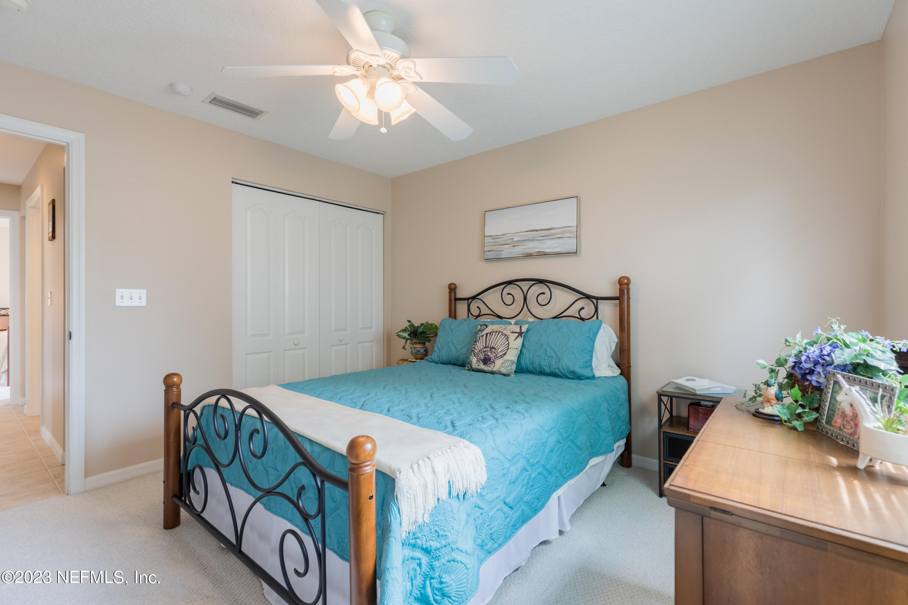293 San Nicolas Way St. Augustine, FL 32080 - Photo 38 of 51 a bedroom with a bed and a chandelier
