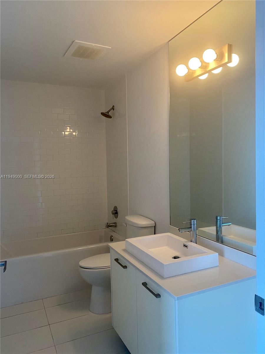 151 Southeast 1st Street, Unit 1108 Miami, FL 33131 - Photo 10 of 10 a bathroom with a sink toilet and mirror