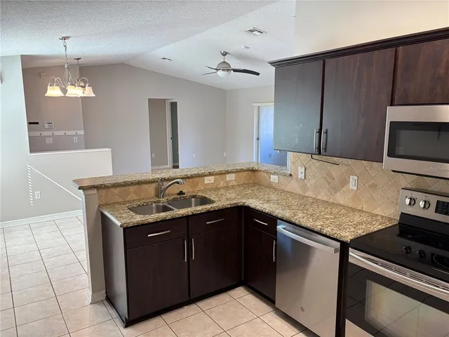 a kitchen with a sink and a stove top oven