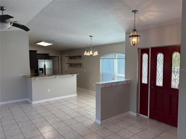 a room with kitchen island a sink a stove and a refrigerator