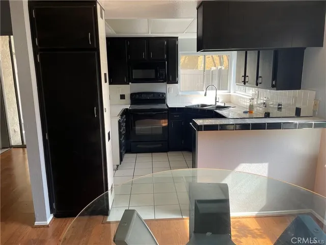 a kitchen with stainless steel appliances a sink stove and refrigerator