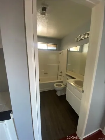 a bathroom with a bathtub sink mirror and toilet