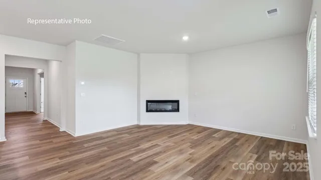a view of kitchen and hall with wooden floor